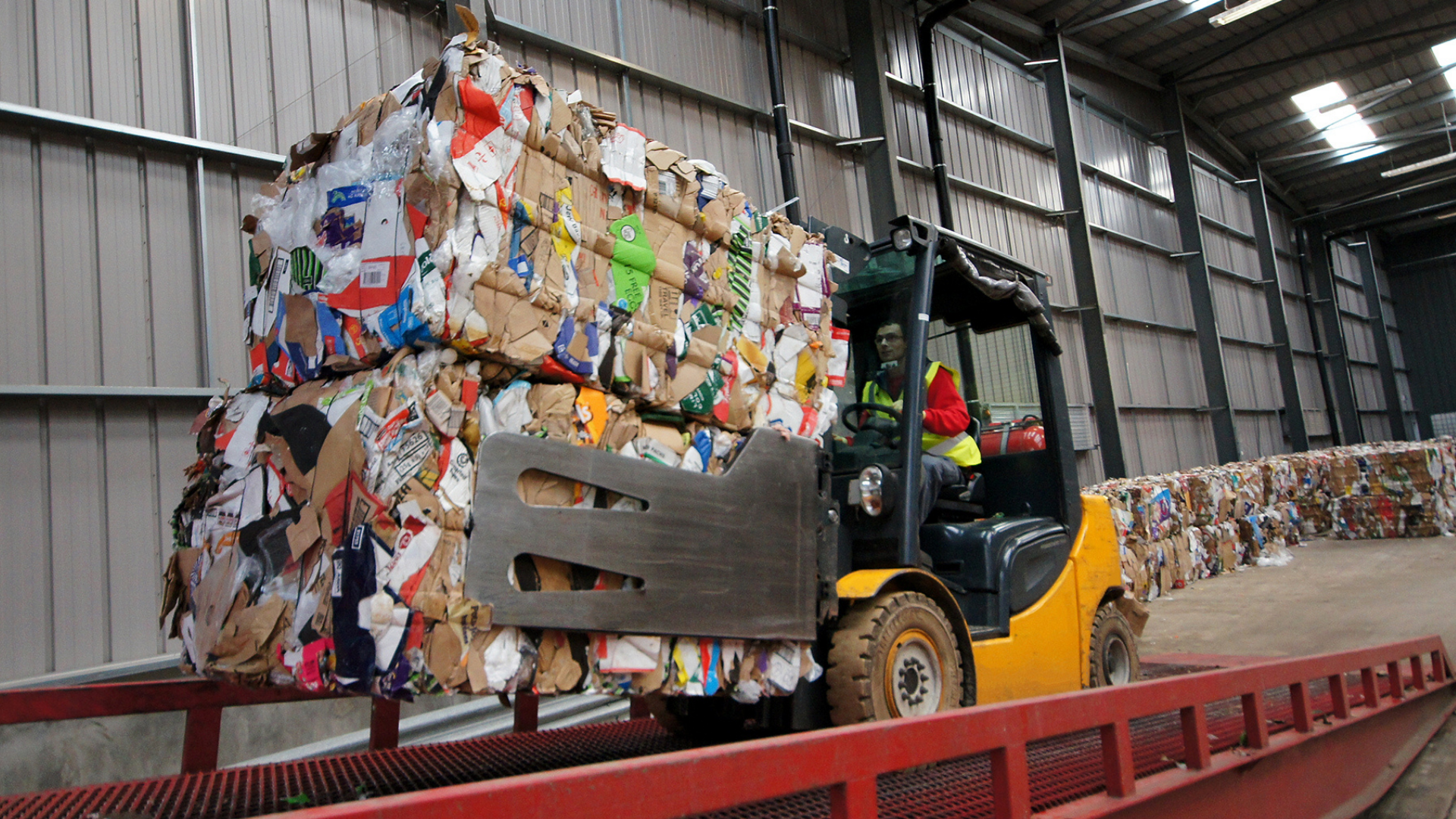 Forklift driver with waste to recycle