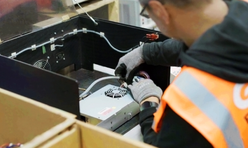 GXO operative repairing electronic device.